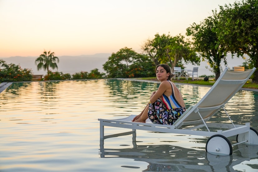 Tania George relaxes by the pool in Kempinski, Jordan © Jack Pearce/Lonely Planet